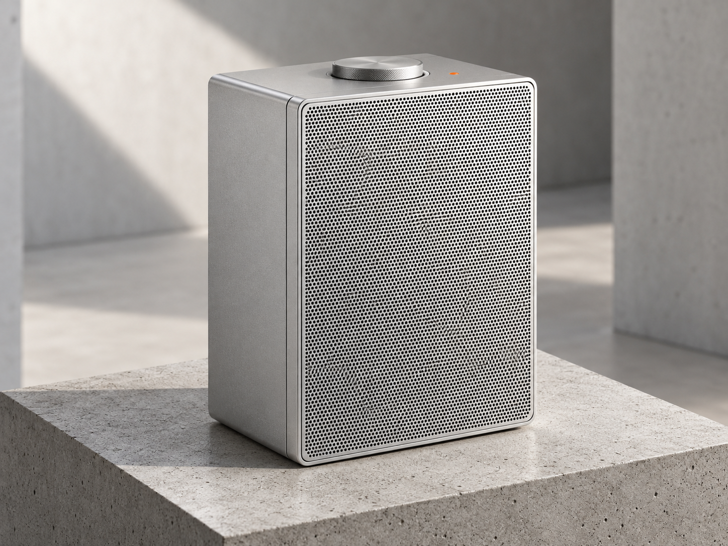 Morrow One wireless speaker in Raw Anodised Aluminium finish resting on a cast concrete plinth